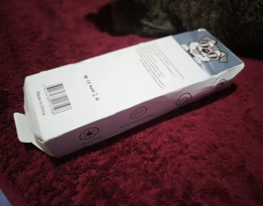 Customer photo of the LED Dog Nail Trimmer box on a red fabric surface