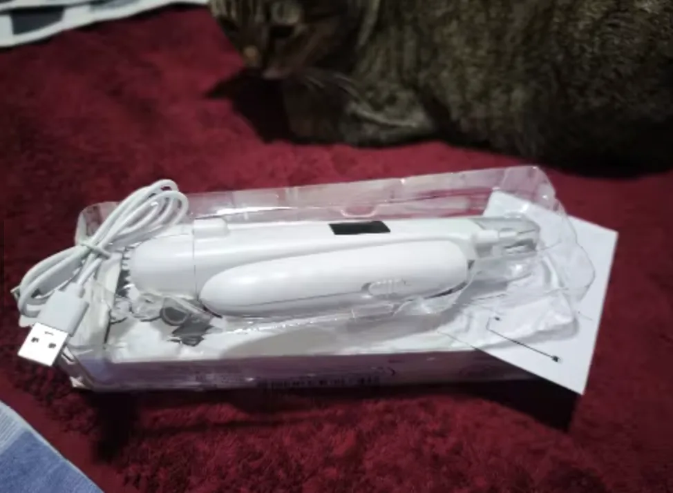 Customer photo of the LED Dog Nail Trimmer kit on a red fabric surface