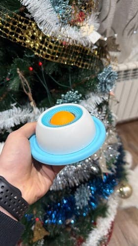 Customer photo of the Treat Dispensing Ball held near a decorated tree