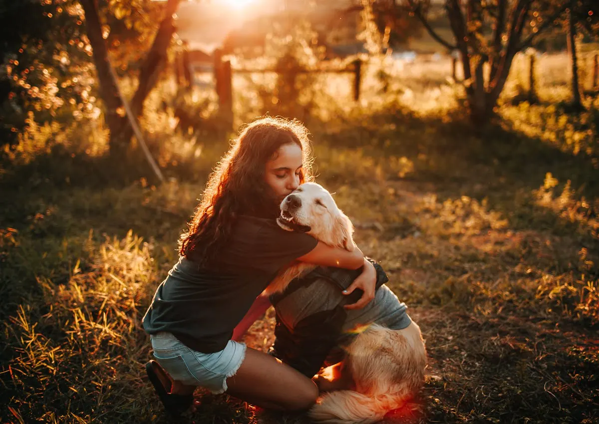 Dog owner hugging a white dog during a sunset walk